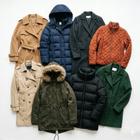 A flat-lay collection of eight different outerwear garments, including trench coats, puffer jackets, and wool coats, in a variety of colors like navy, green, brown, and orange, arranged neatly on a white background.